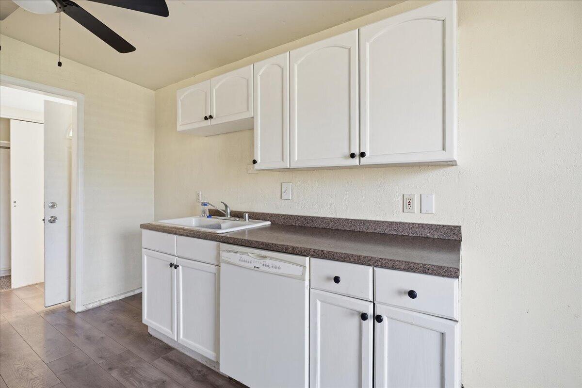2706 68th Street Lubbock, TX 79413 - Photo 9 of 20 a kitchen with granite countertop white cabinets and sink