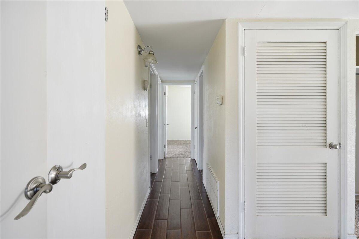 2706 68th Street Lubbock, TX 79413 - Photo 10 of 20 a view of a hallway with wooden floor and closet area