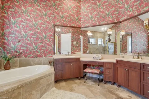 a bathroom with a large tub sink and double vanity