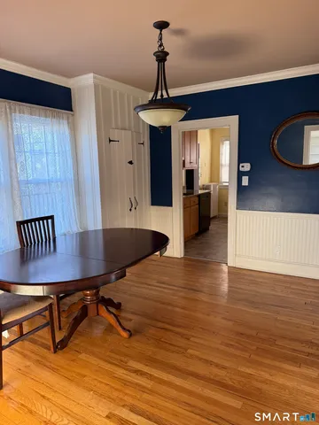 a view of a dining room with furniture window and wooden floor