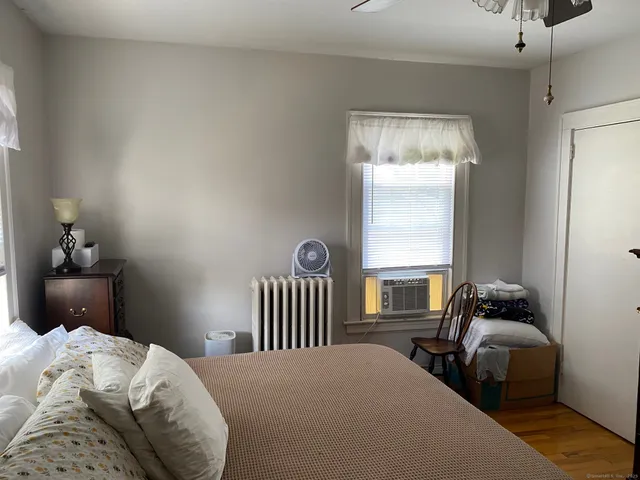 a bedroom with a bed and a window