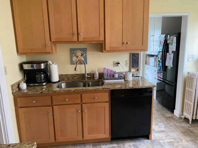 a kitchen with stainless steel appliances granite countertop a refrigerator sink and cabinets