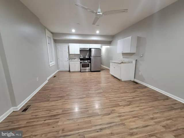 a view of a kitchen with a sink and a window