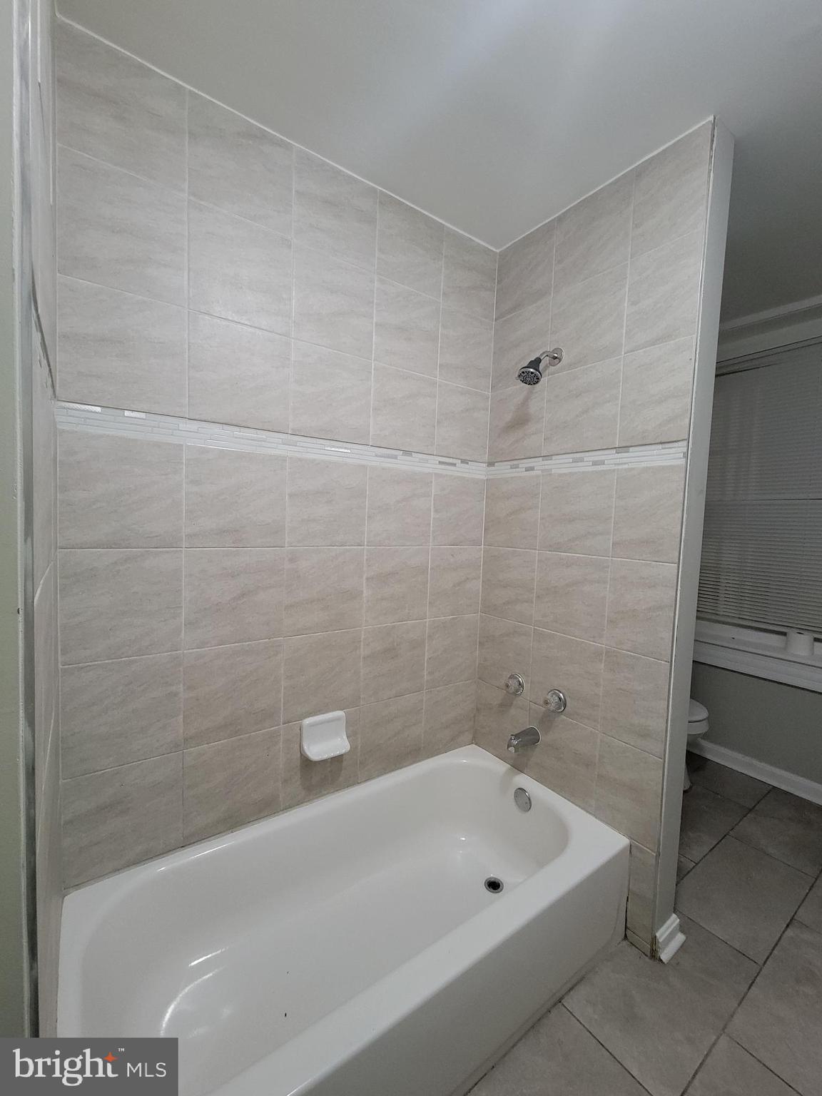 1217 Hollins Street, Unit 1 Baltimore, MD 21223 - Photo 6 of 6 a bathroom with a bathtub