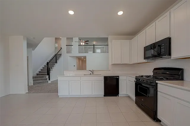 a kitchen with a stove top oven and cabinets