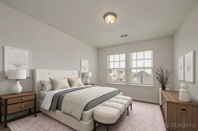 a bedroom with a bed and a large window