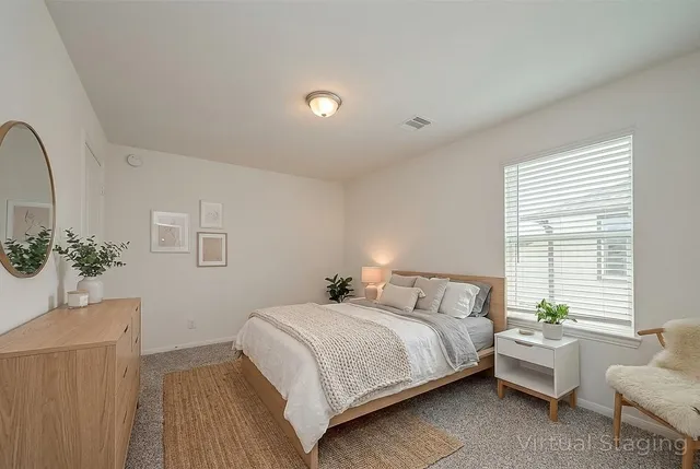 a bedroom with a bed and a couch