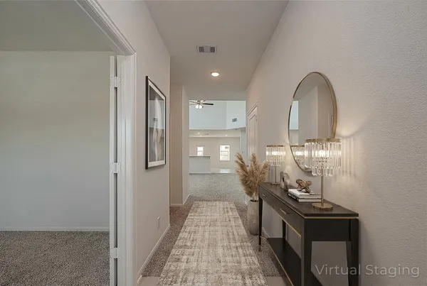 a view of a hallway with wooden floor and staircase