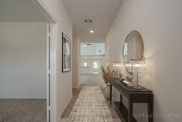 a view of a hallway with wooden floor and staircase