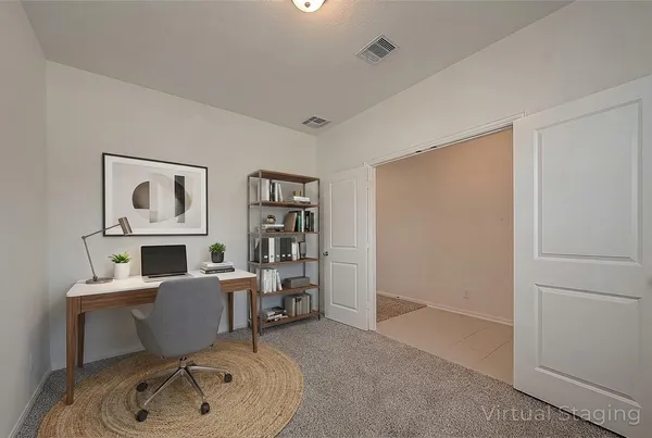 a room with furniture a rug and white walls