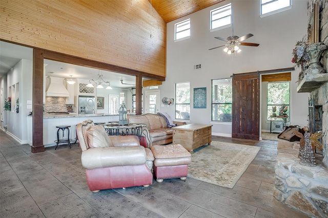 a living room with furniture and chandelier