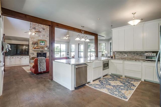a kitchen with a sink stove and white cabinets