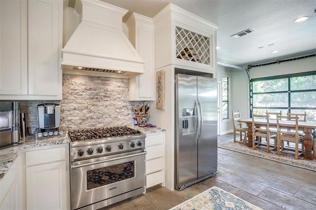 a kitchen with a stove and refrigerator