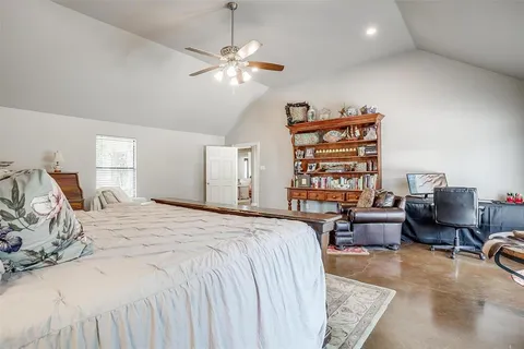 a bedroom with a bed furniture and decor