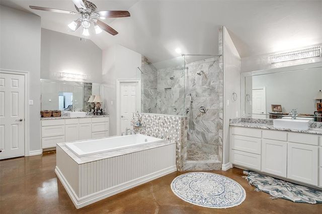 a bathroom with a sink a toilet tub and shower