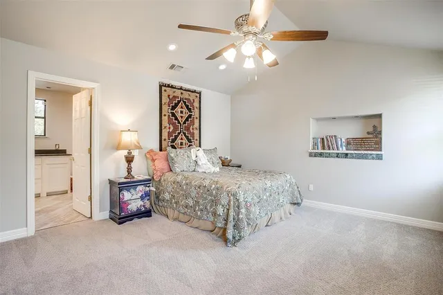 a bedroom with bed and a chandelier