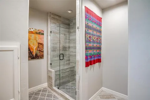 a bathroom with a shower and a sink