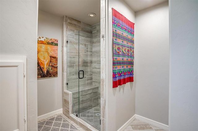 a bathroom with a shower and a sink