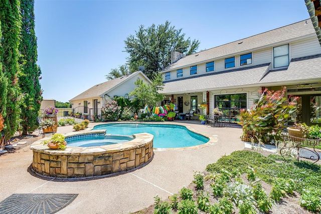 a view of a house with swimming pool and sitting area