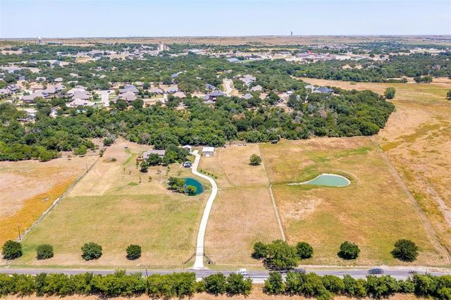 an aerial view of residential houses with outdoor space and river