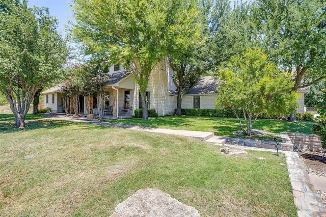 a house with huge green field in front of it
