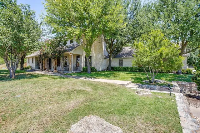 a house with huge green field in front of it