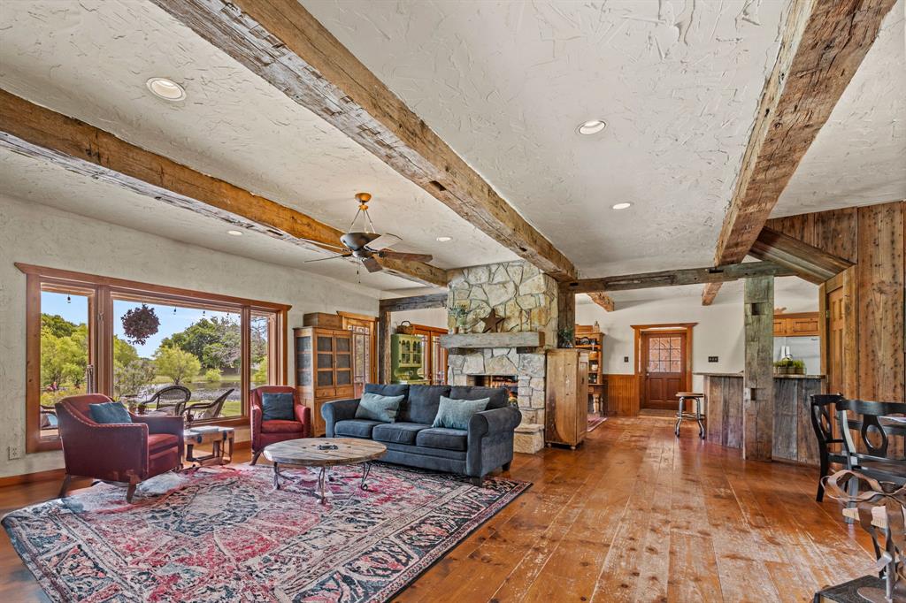 535 Cullins Road Rockwall, TX 75032 - Photo 5 of 23 Recently re-stained soft pine floors, massive solid oak beamed ceilings & a see-thru fireplace that adds warmth & character to the newly-painted kitchen