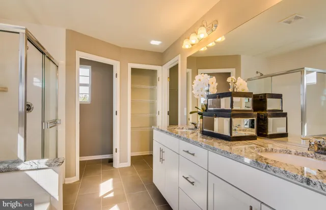 a kitchen with granite countertop a sink and a refrigerator