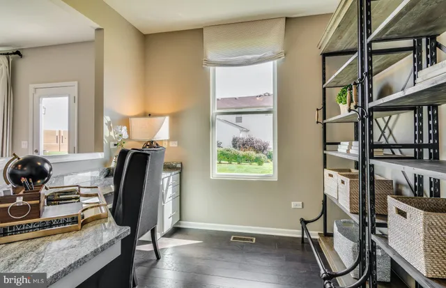 a view of a livingroom with furniture and workspace