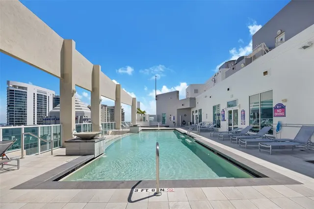 a swimming pool with outdoor seating and yard