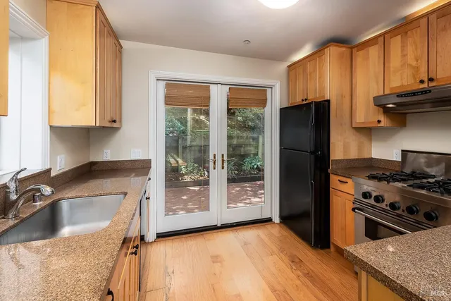 a kitchen with a stove a sink and a refrigerator