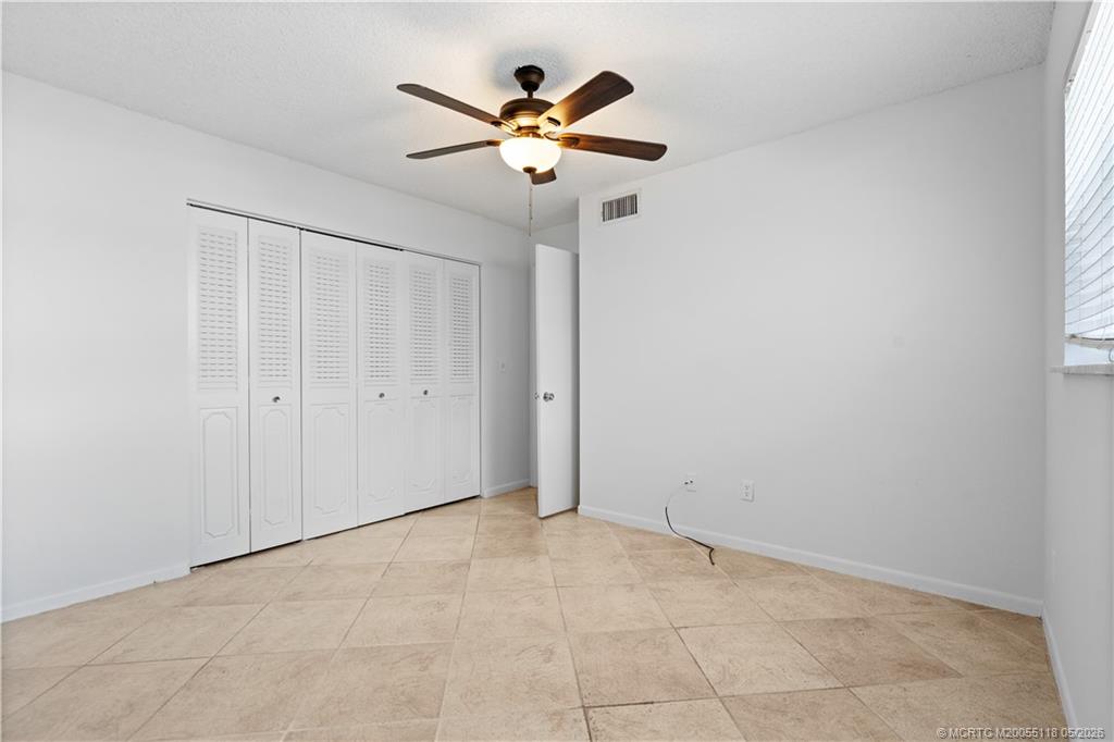2118 Southeast Edler Drive, Unit B Stuart, FL 34994 - Photo 12 of 20 an empty room with ceiling fan