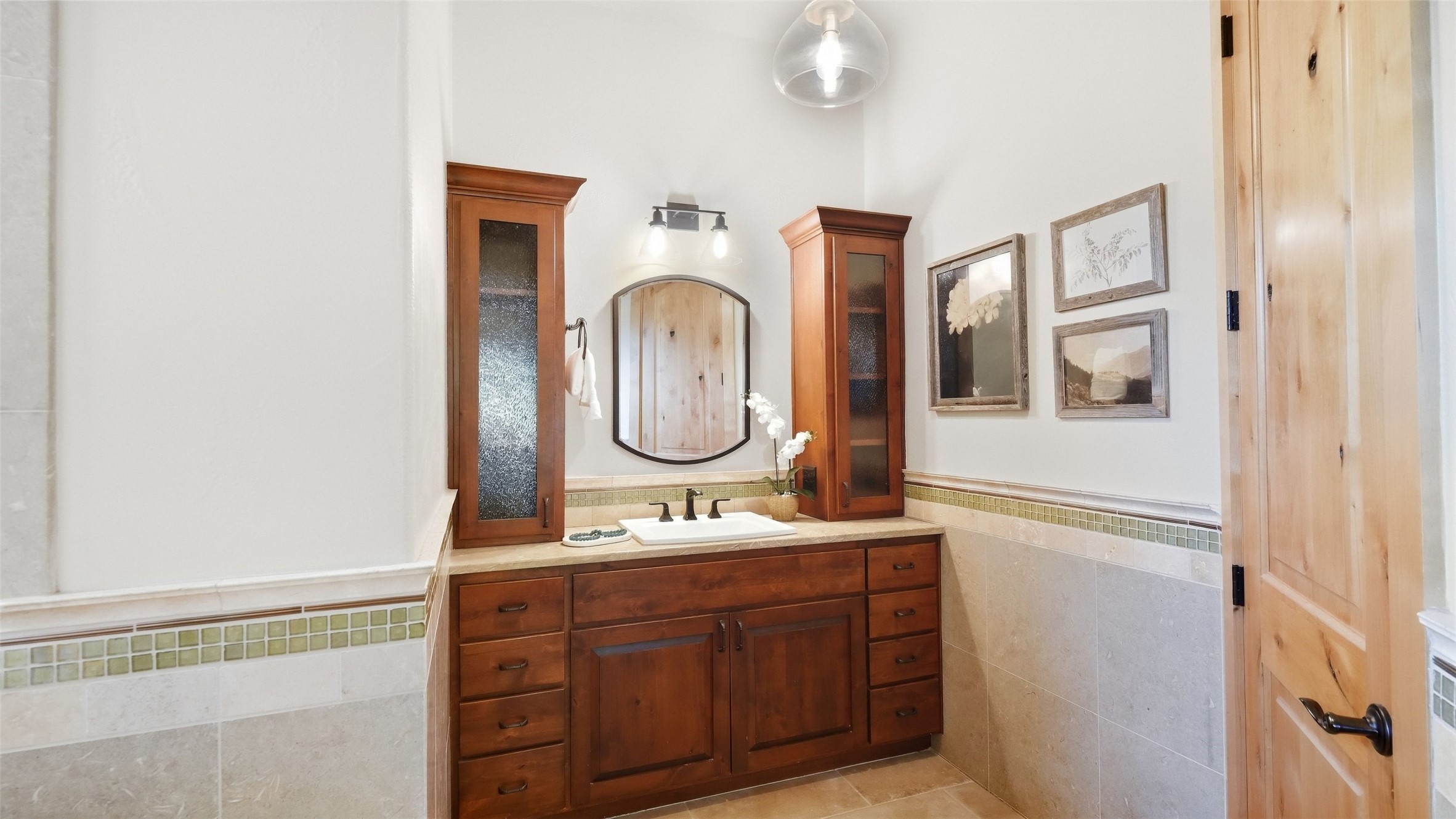 5910 Hudson Bend Road Austin, TX 78734 - Photo 25 of 40 Fine woodwork and tiled wainscoting define this inviting vanity space.