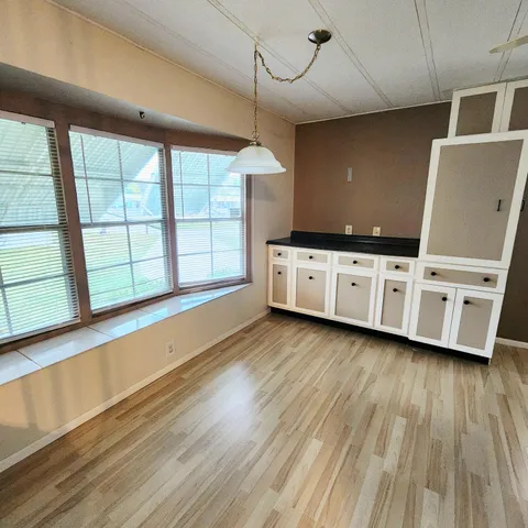 a view of a house with swimming pool and sitting area