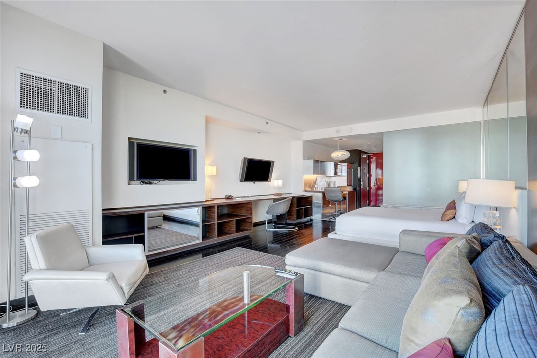 4381 West Flamingo Road, Unit 1206 Las Vegas, NV 89103 - Photo 11 of 27 Living area featuring wood finished floors
