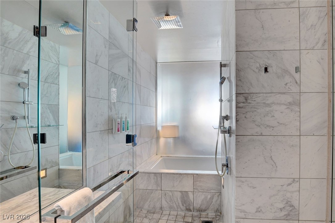 4381 West Flamingo Road, Unit 1206 Las Vegas, NV 89103 - Photo 15 of 27 Bathroom featuring a shower stall and a relaxing tiled tub