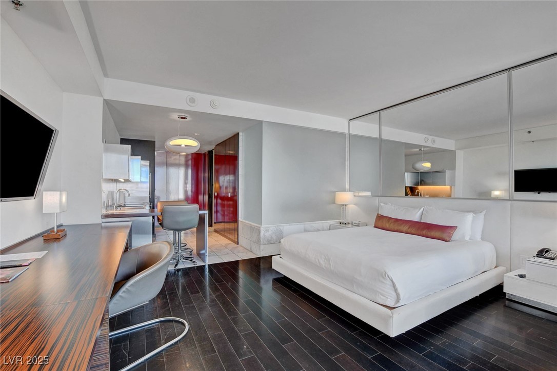 4381 West Flamingo Road, Unit 1206 Las Vegas, NV 89103 - Photo 2 of 27 Bedroom with wood finished floors and a sink