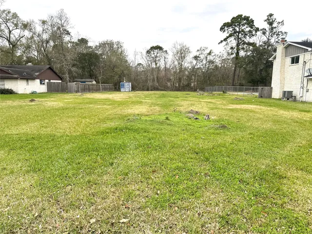 a view of a large swimming pool and trees in the background
