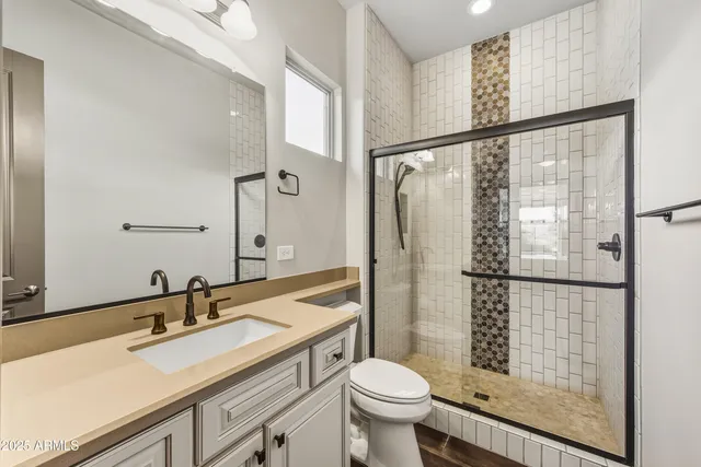 a bathroom with a sink toilet and shower