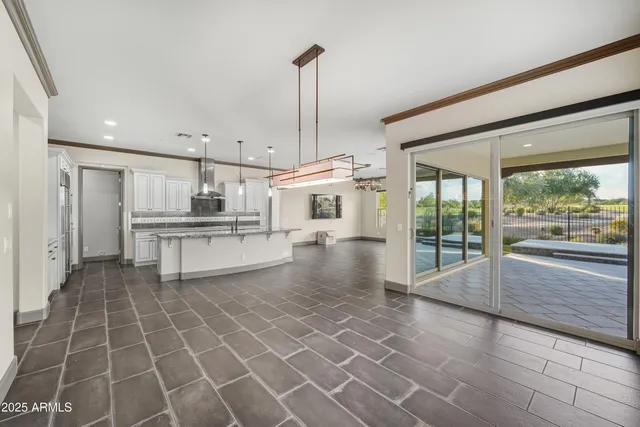 a view of a kitchen with kitchen island a counter top space a sink and stainless steel appliances