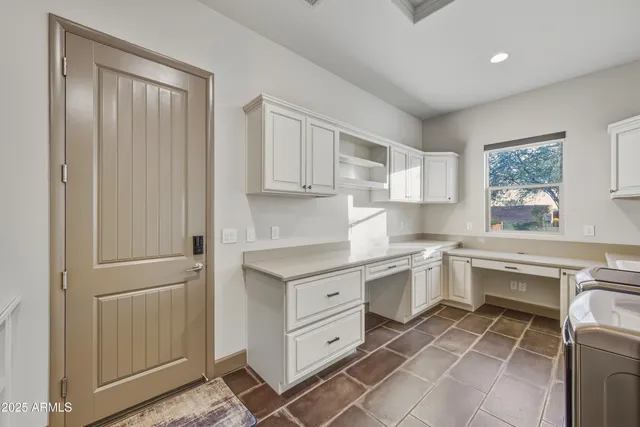 a kitchen with white cabinets and white appliances
