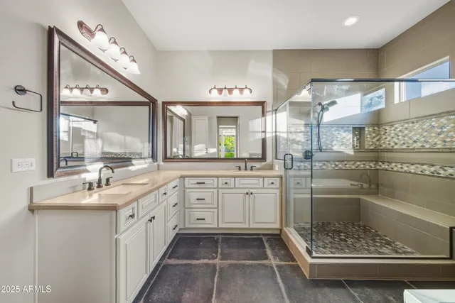 a bathroom with a double vanity sink and a mirror
