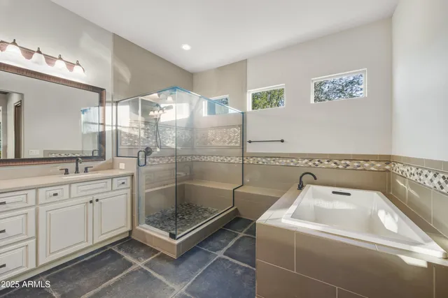 a bathroom with a shower a sink and a mirror