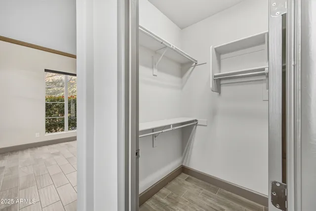 a view of an empty walk in closet with empty racks