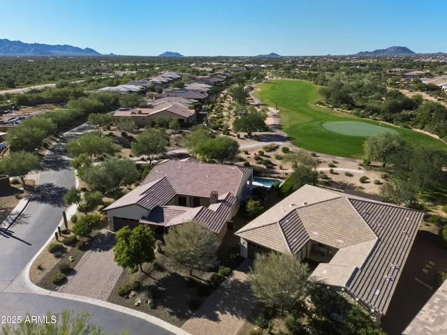 an aerial view of residential house with outdoor space and river all around