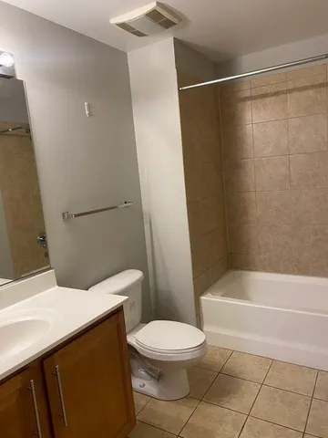 a bathroom with a toilet a sink and shower