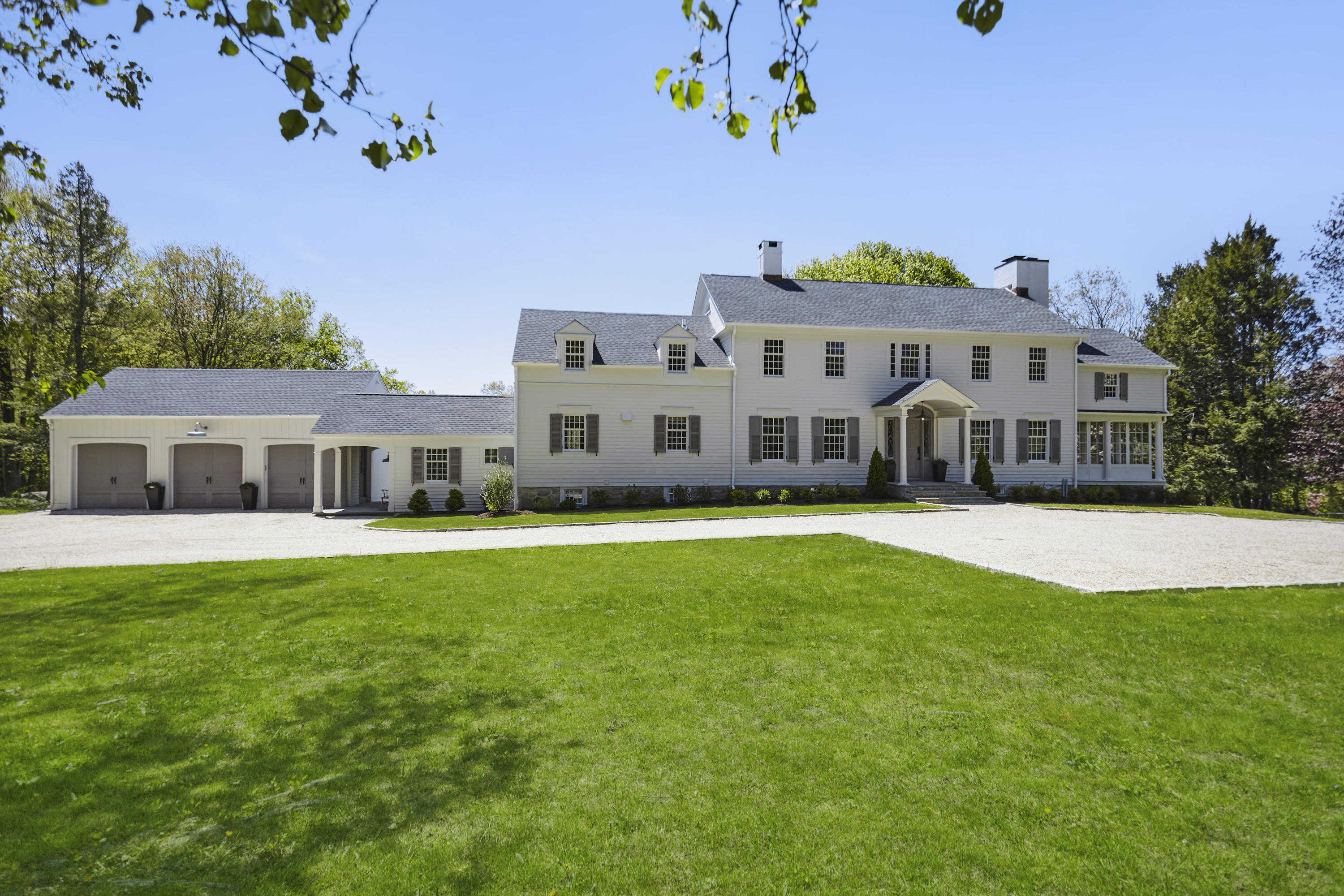 756 Ponus Ridge Road New Canaan, CT 06840 - Photo 1 of 54 a front view of a house with a garden