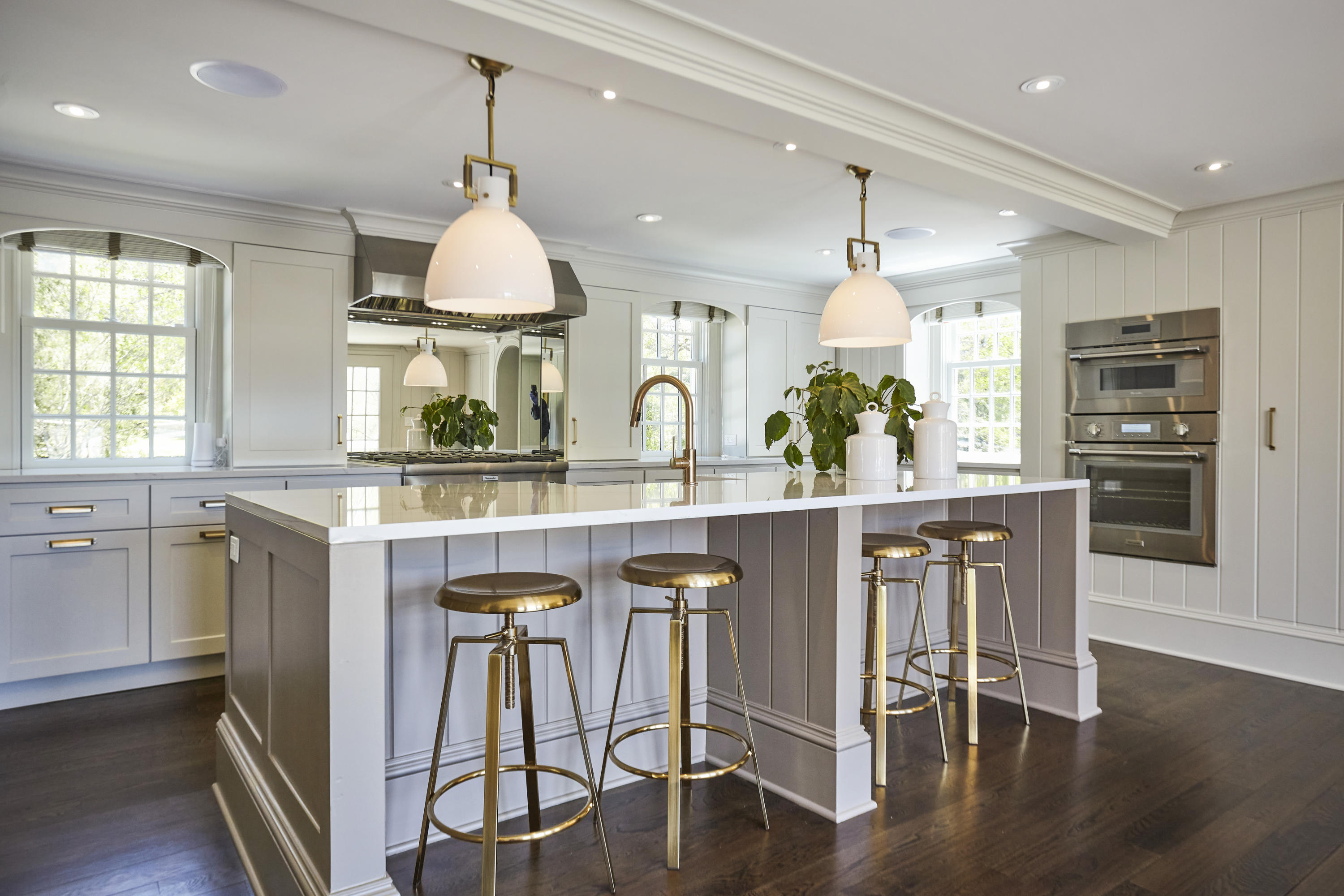756 Ponus Ridge Road New Canaan, CT 06840 - Photo 12 of 54 a kitchen with stainless steel appliances granite countertop a stove a sink dishwasher a dining table and chairs with wooden floor