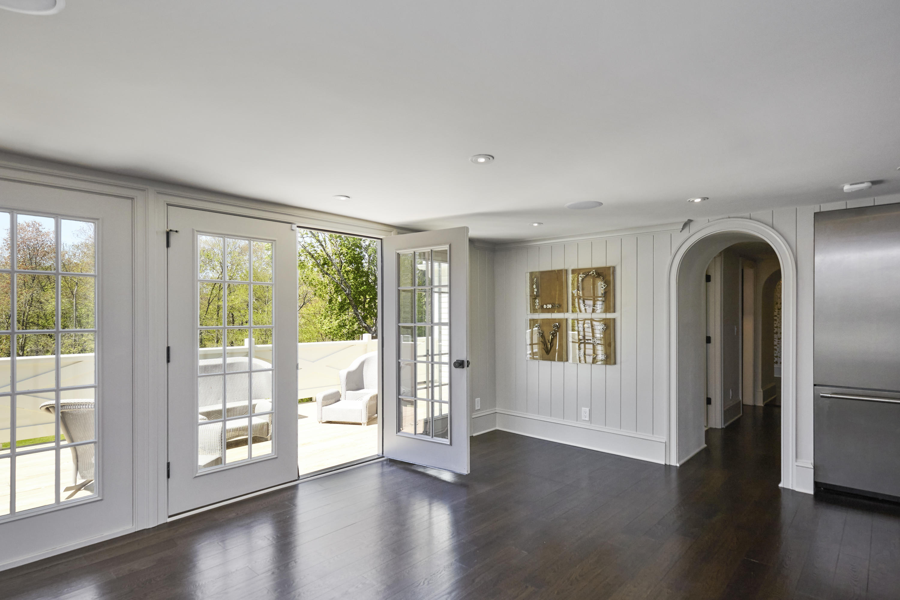 756 Ponus Ridge Road New Canaan, CT 06840 - Photo 14 of 54 a view of an empty room with wooden floor and a window