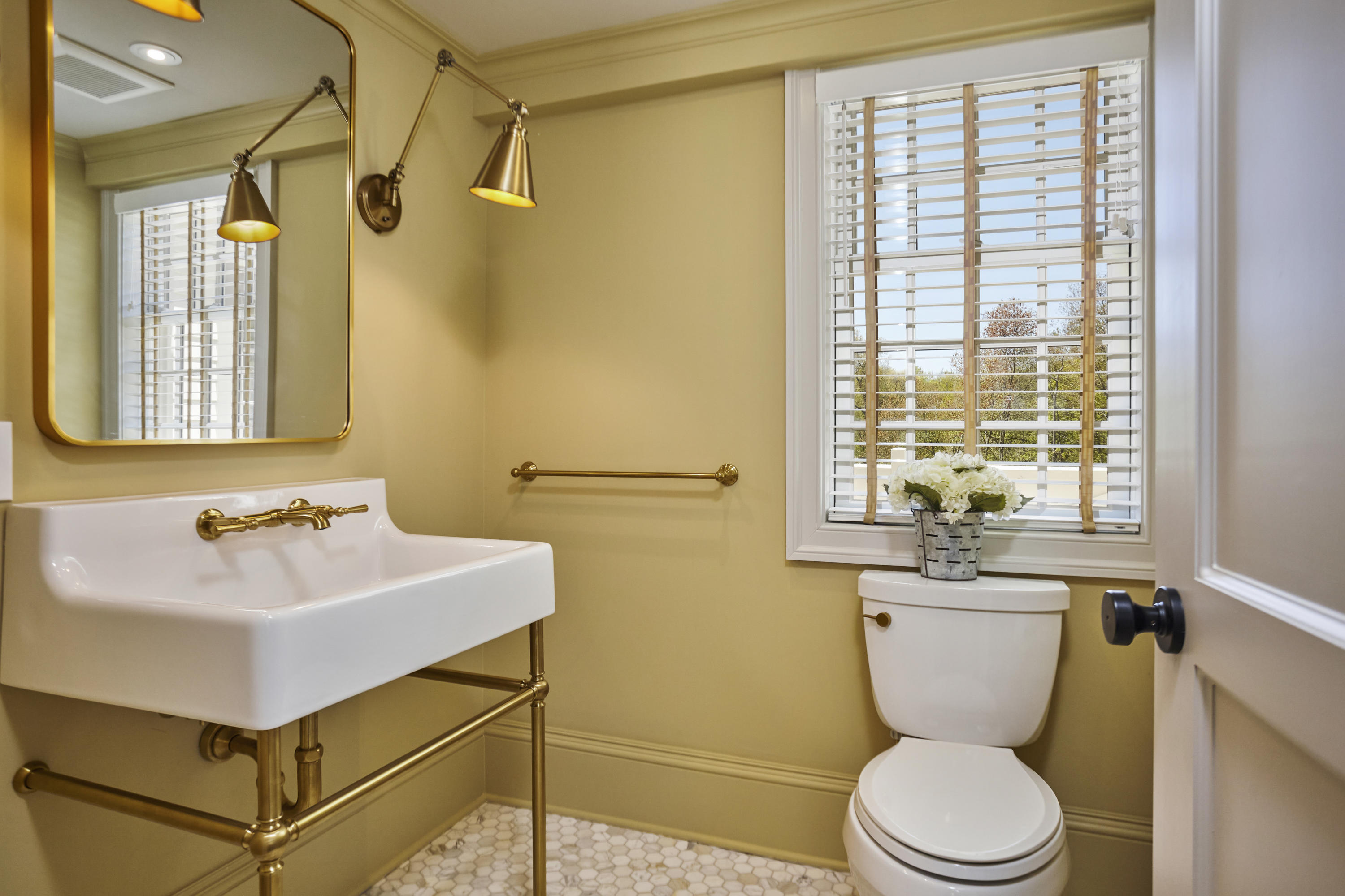 756 Ponus Ridge Road New Canaan, CT 06840 - Photo 17 of 54 a bathroom with a sink a toilet and a mirror